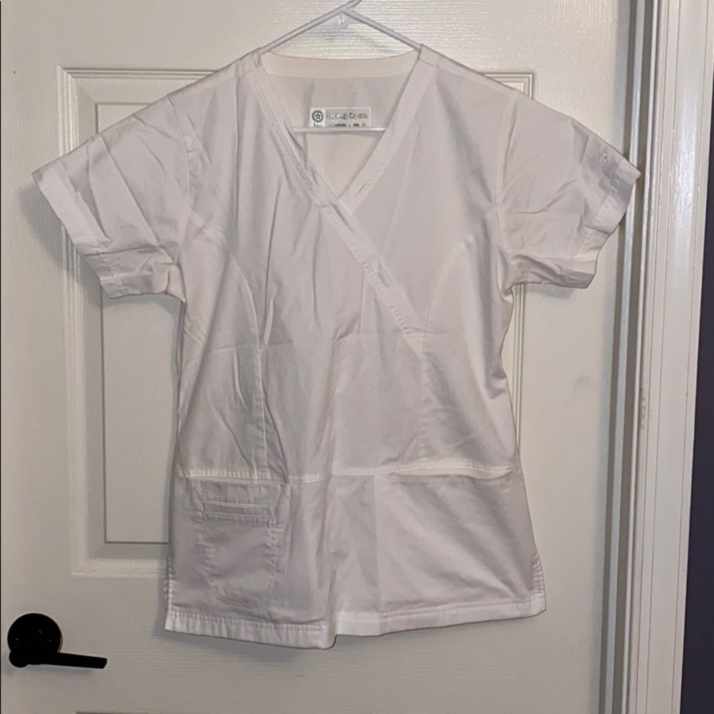 Two pocket white scrub top.